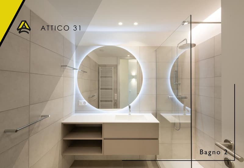Modern bathroom with a large round mirror, a white sink, a glass shower enclosure, and a white cabinet with shelves.