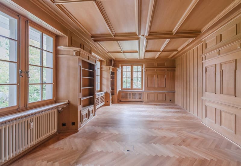 wooden floor, wooden walls, large windows, built-in shelves, radiator