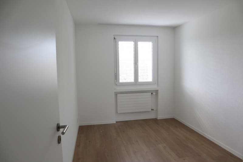 empty room, white walls, wooden floor, window, radiator