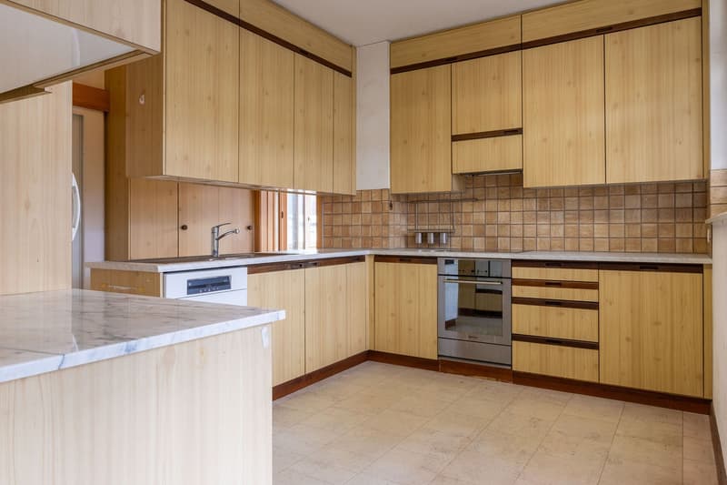 modern wooden cabinets, marble countertop, stainless steel appliances, tiled flooring