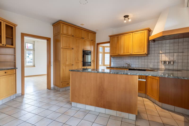 modern kitchen, wooden cabinets, granite countertops, built-in oven, stainless steel faucet
