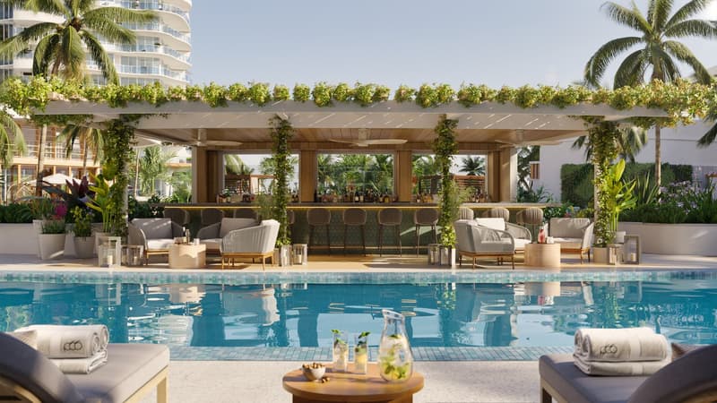 Outdoor bar with a pool, lounge chairs, tables, plants, and a view of the city