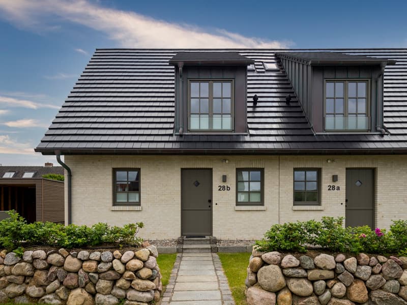 2 story house, brick wall, gray roof, gray doors, windows, stone wall entrance