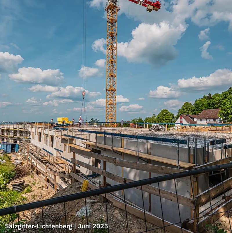 Under construction building, concrete foundation, steel reinforcement, scaffolding, crane, workers
