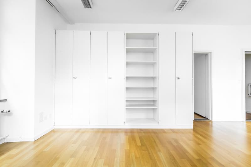 empty room, white walls, wooden floor, built-in wardrobes, open door