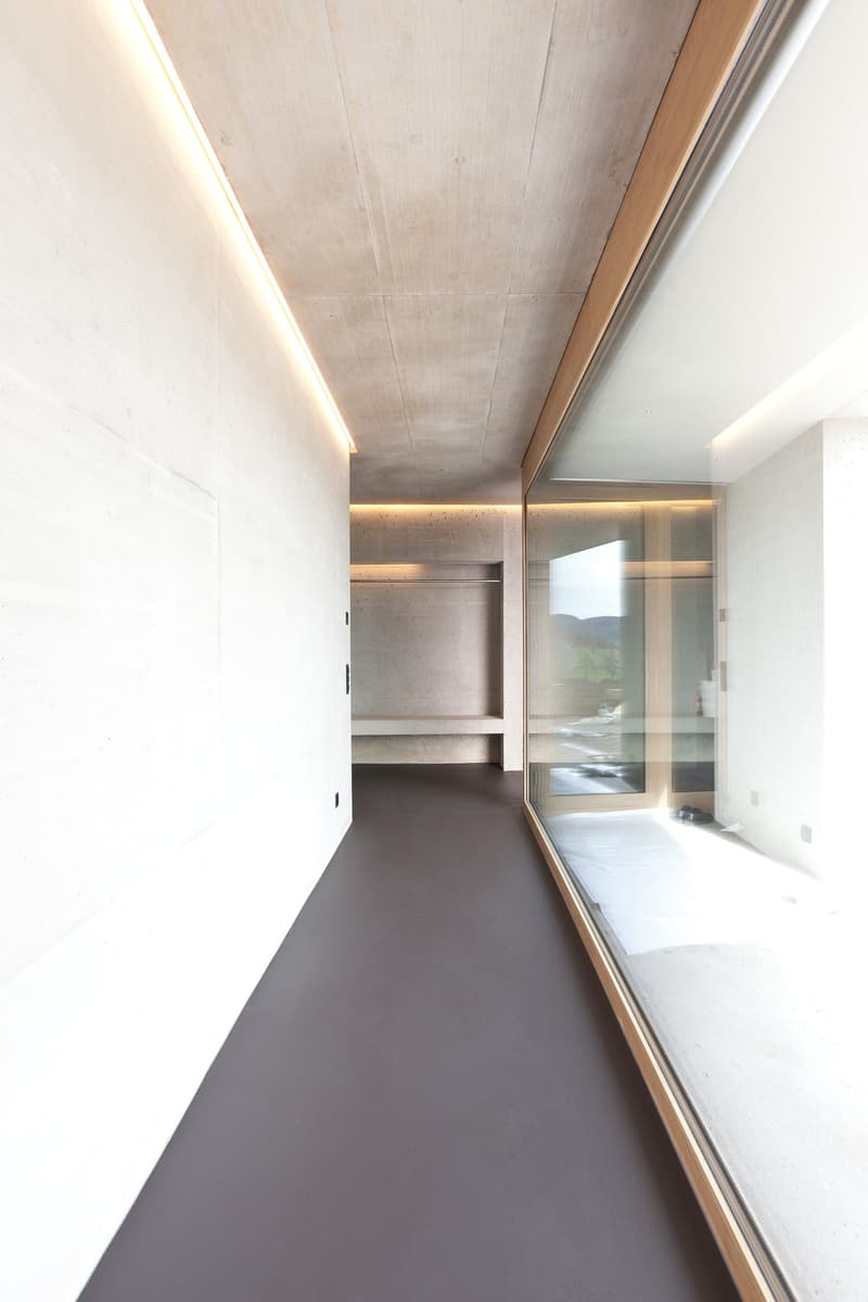 modern design, white walls, gray floor, large glass windows, built-in wardrobe, view of the outside