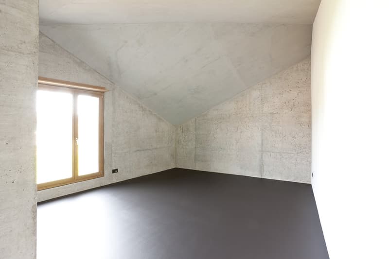 empty room, concrete walls, wooden window frame, black floor