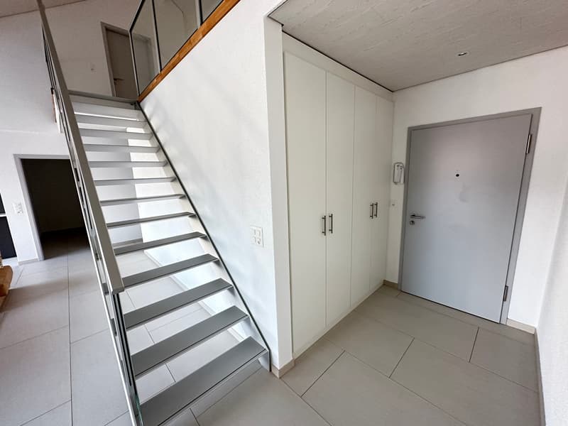white tiled floor, white walls, metal staircase, white cabinets, white door