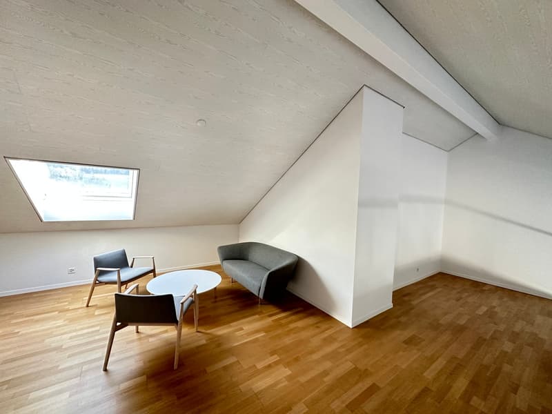 empty room, wooden floor, white walls, gray sofa, white coffee table, two chairs, skylight window