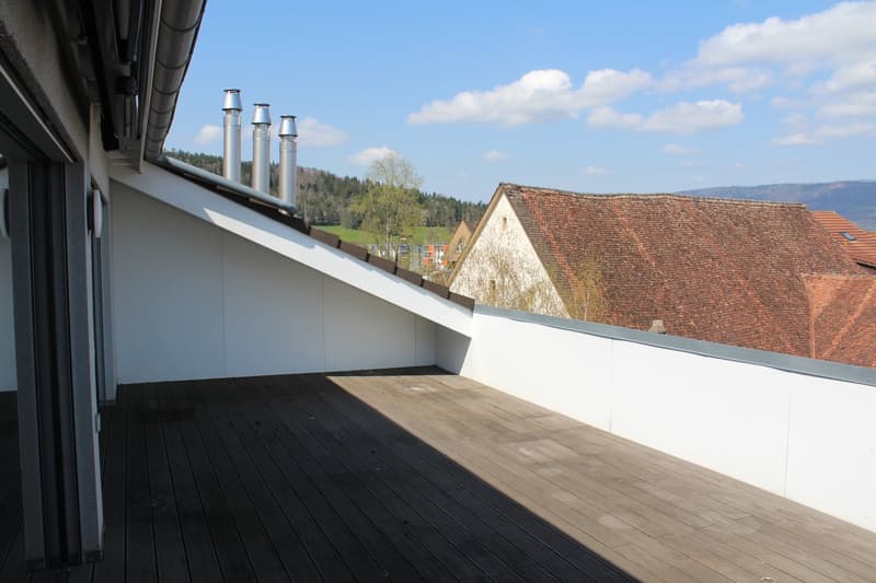 wooden floor, white walls, metal railing, open view, chimneys