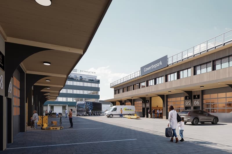 Exterior of a commercial building with a parking lot, multiple vehicles, and people walking.