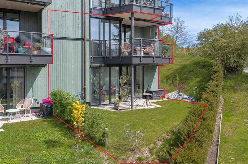 2 story house, green exterior, glass windows, balconies, garden, outdoor furniture