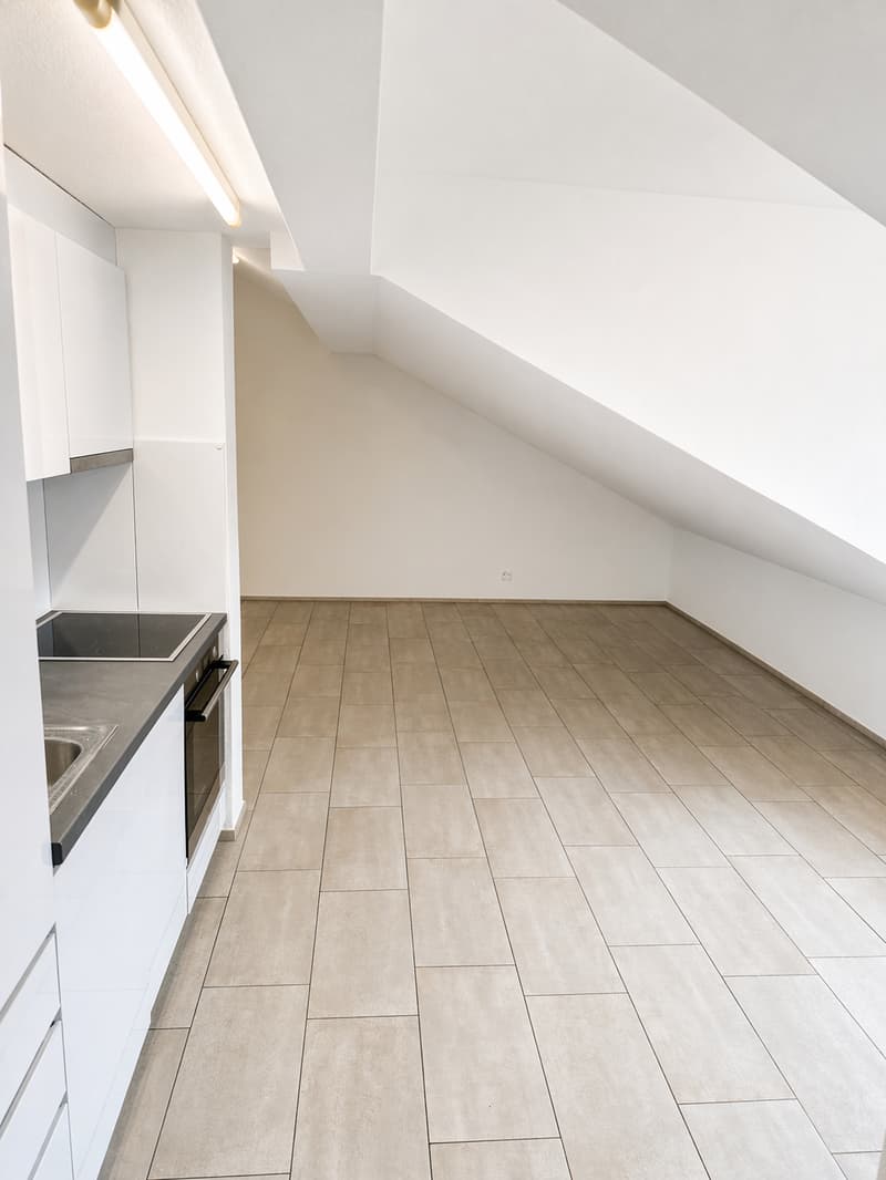 empty kitchen with tiled floor, white cabinets, stainless steel sink, electric stove, ceiling light