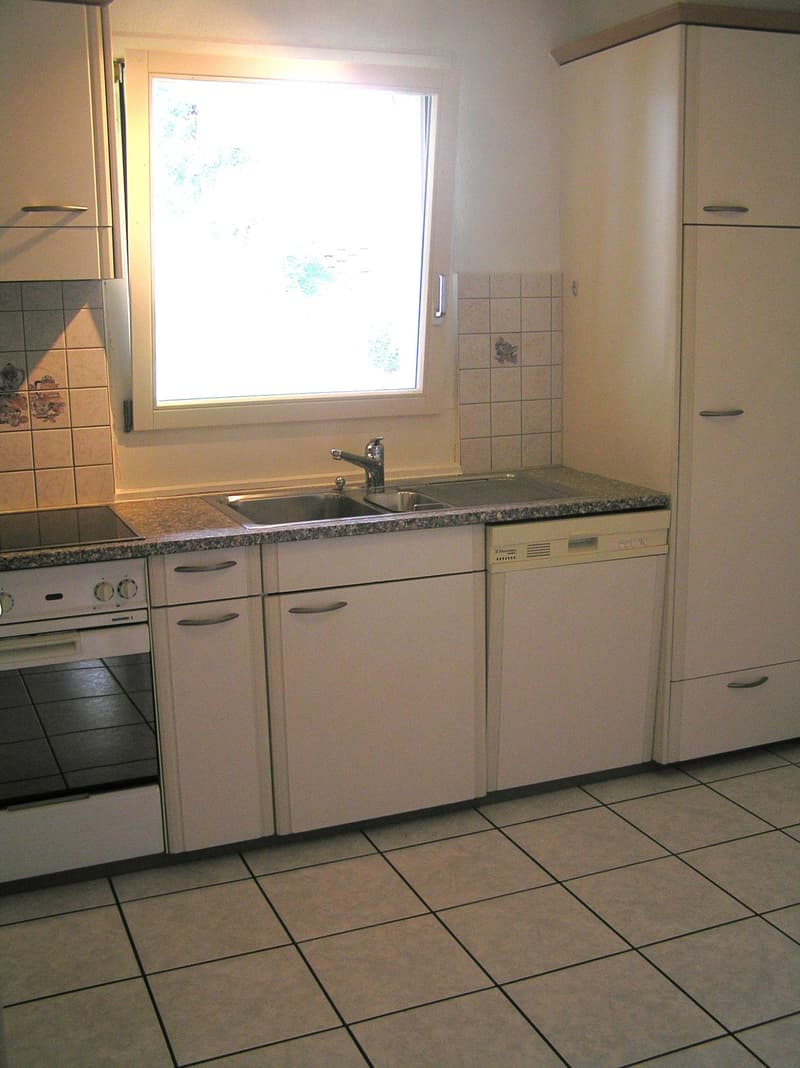 kitchen with white cabinets, granite countertop, sink, dishwasher, oven, window
