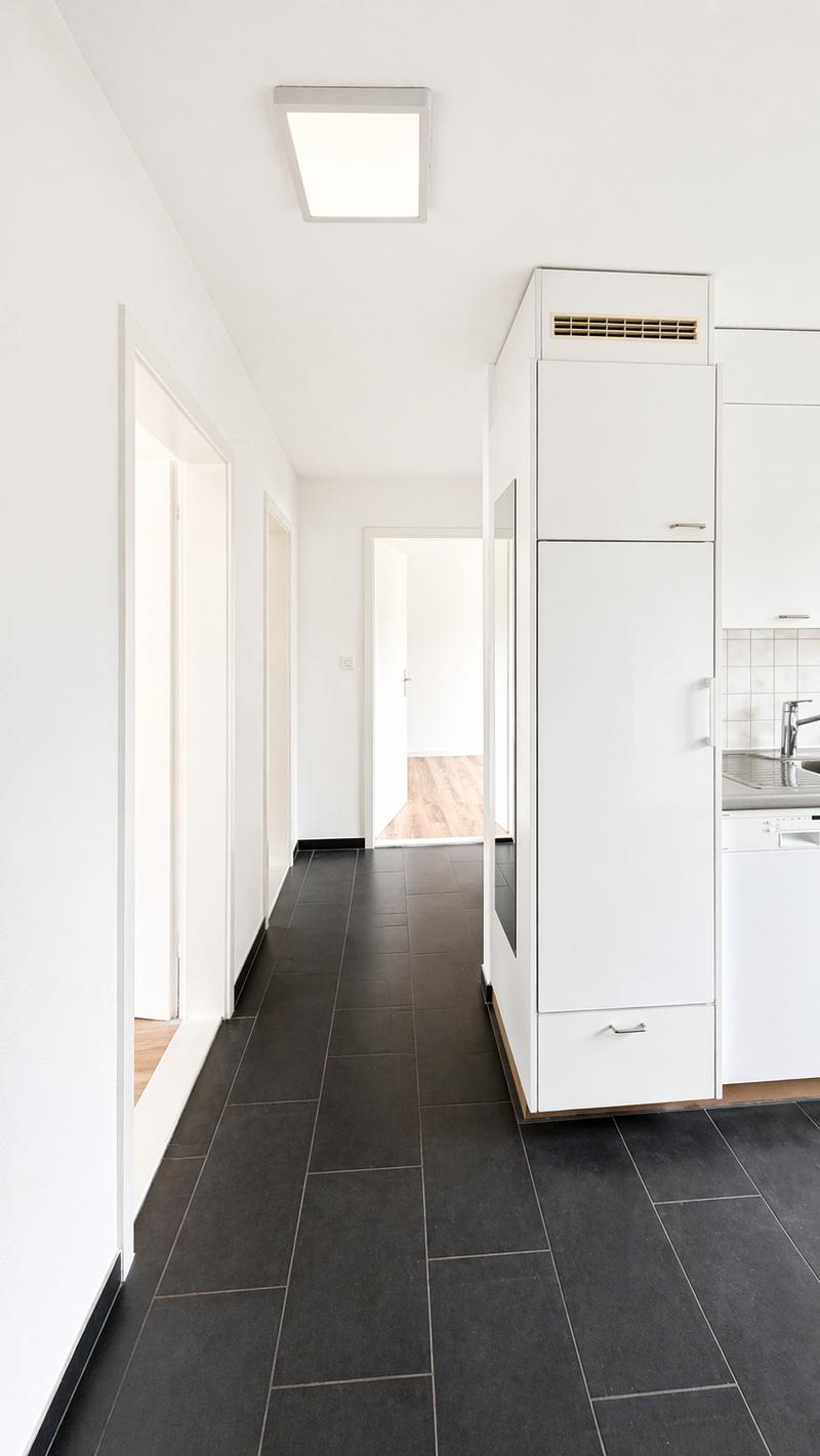 modern kitchen with white cabinets, black tiled floor, white ceiling light, sink, dishwasher, washing machine