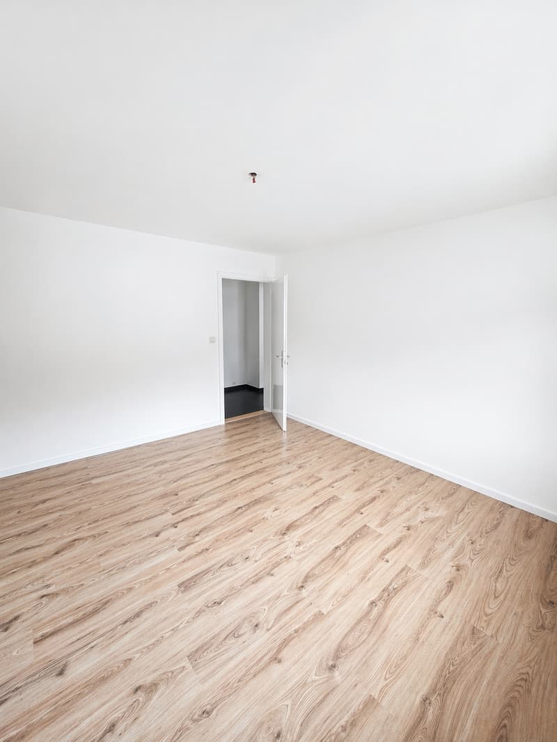 empty room, wooden floor, white walls, open door