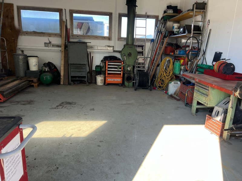 Garage with tools, equipment, and storage boxes