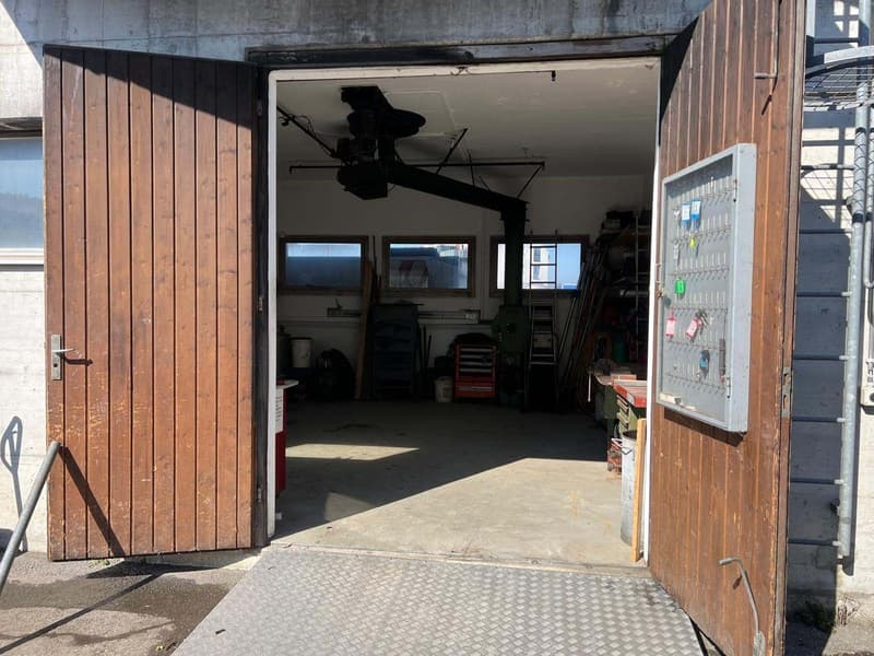 wooden doors, concrete floor, metal ceiling, tools and equipment inside