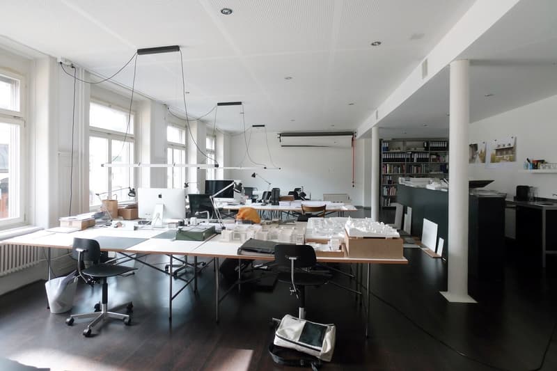 office space with desks, chairs, computer monitors, bookshelves, windows, radiator