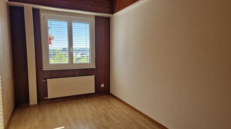 wooden floor, brown wooden walls, white wall, window with blinds, radiator