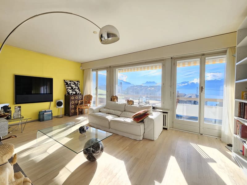 Séjour avec cheminée, sortie sur le balcon, et superbe vue sur le lac