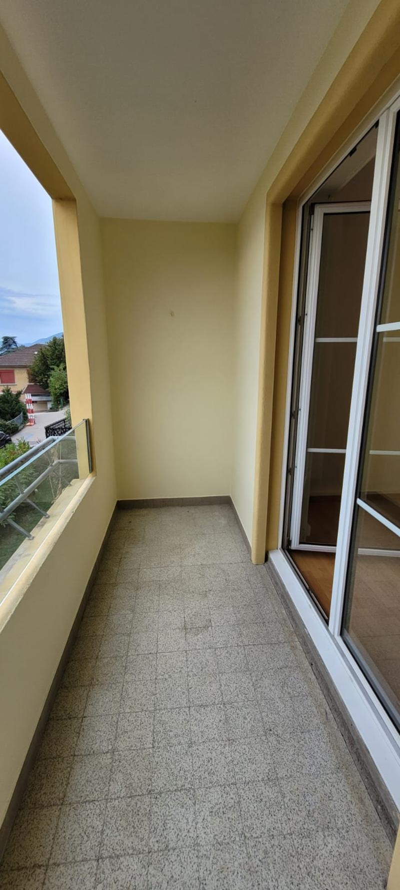 Empty balcony with windows and glass railing