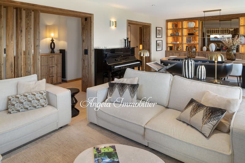 modern living room with two sofas, coffee table, piano, wooden cabinets, shelves, lamps, carpet