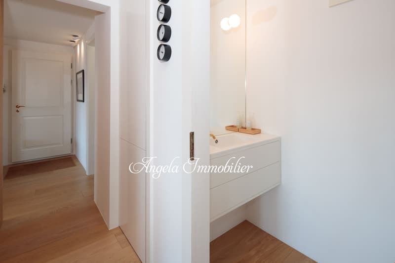 wooden floor, white walls, entrance with door, hallway, mirror, washbasin with soaps