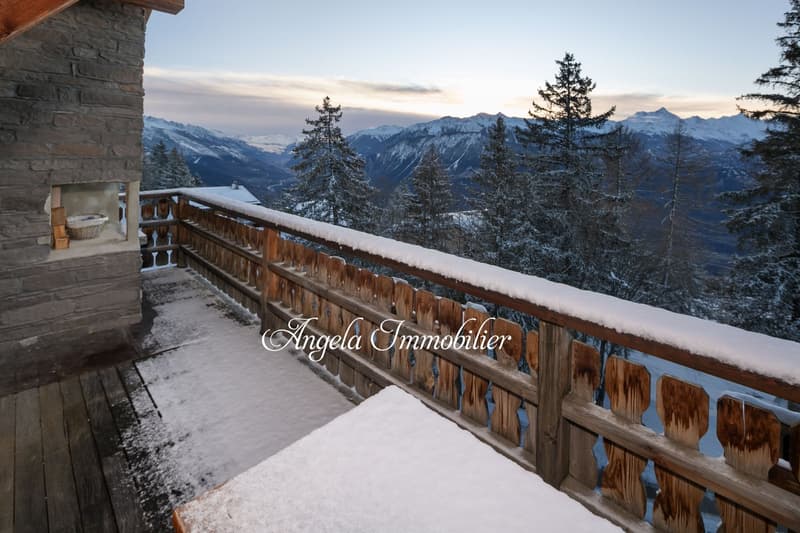 wooden railing, wooden floor, snow, pine trees, mountains, sunset