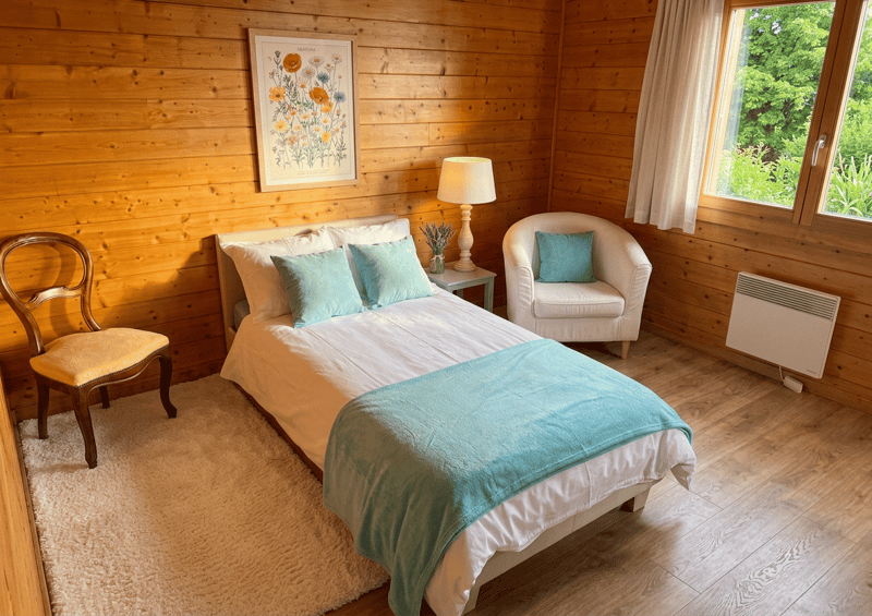 bedroom with bed, chair, lamp, rug, picture, heater, window