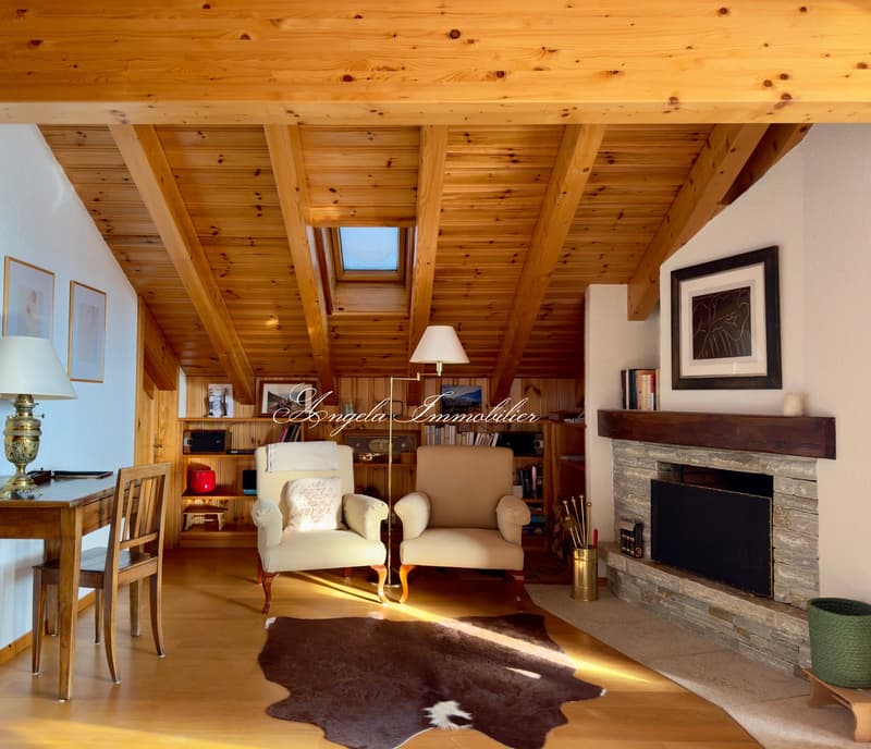 wooden ceiling, fireplace, wooden floor, desk, chairs, lamp, armchairs, rug, shelves, books, picture frames