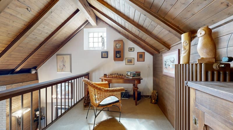 Wooden ceiling, desk with chess, wicker chair, wall paintings, wooden cabinet, window