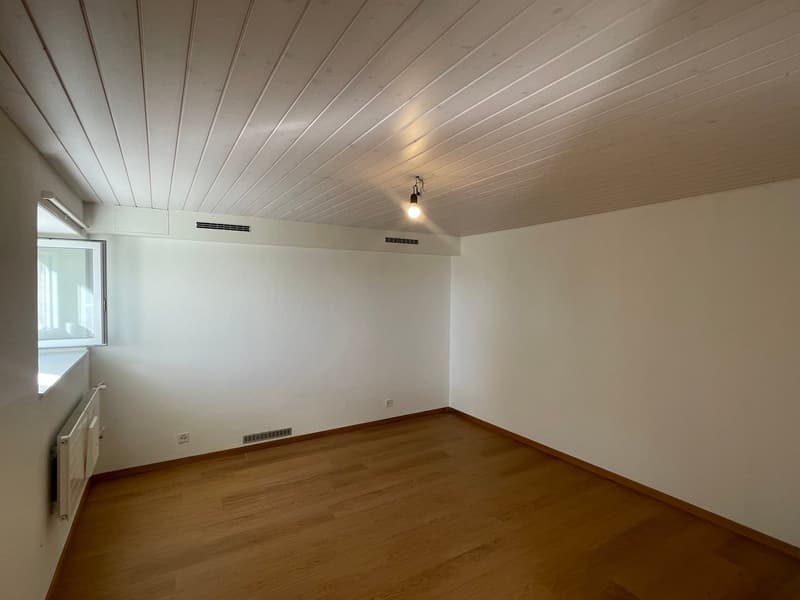 empty room with white walls and ceiling, wooden floor, window