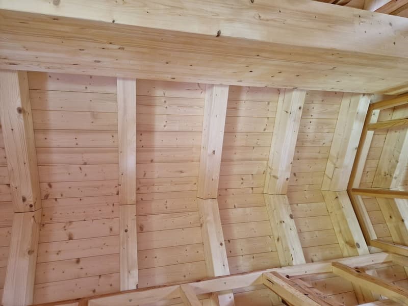 wooden ceiling beams, wooden paneling, unfinished wooden rafters