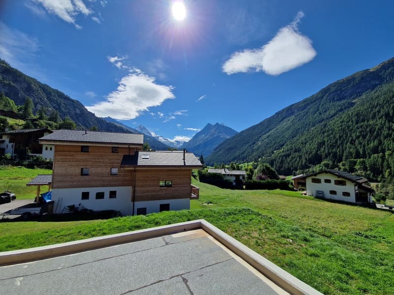 Mountain house, wooden facade, gray roof, green grass, scenic mountain view