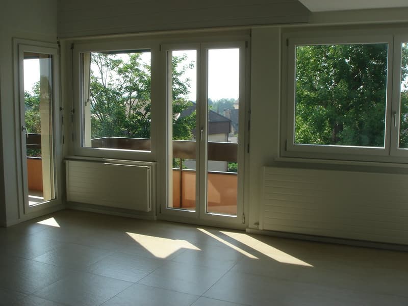 empty room, large windows, balcony, tiled floor, white walls, white radiators