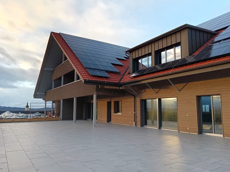 modern house, solar panels on roof, large glass windows, wooden exterior, gray tiled floor
