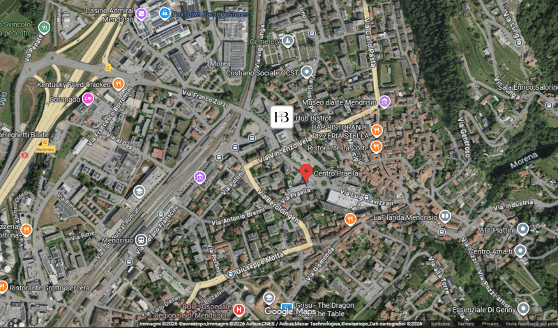 Aerial view of a town with various landmarks and establishments marked, including restaurants, a cemetery, and a factory.