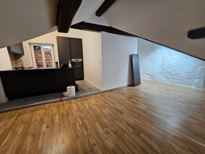wooden floor, kitchen area, open beam ceiling, large window