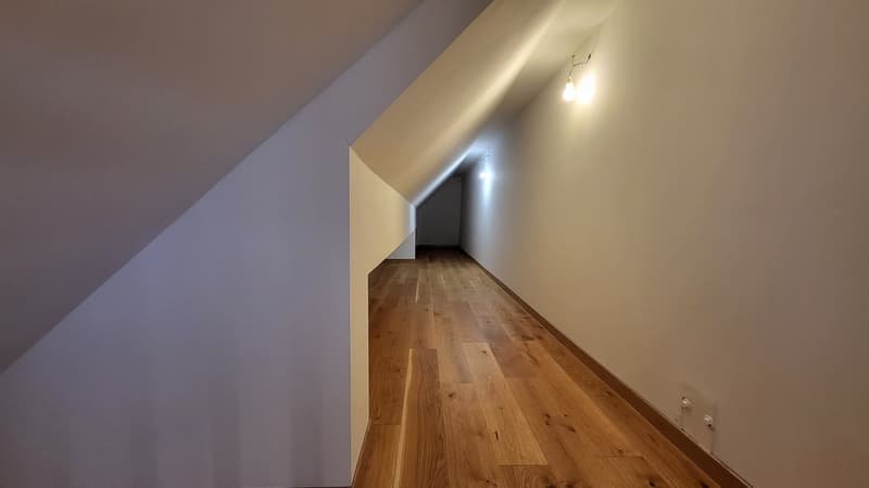 wooden floor, white walls, ceiling lights, power outlet