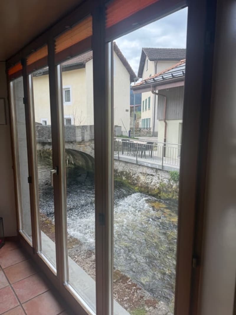 sliding glass doors, view of a river and a bridge