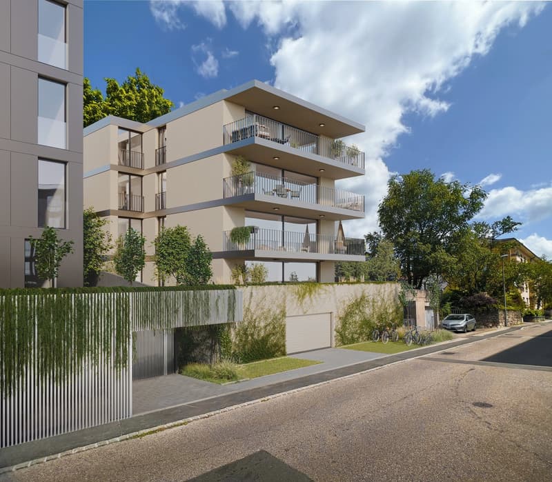Residential building with multiple balconies, garage, fenced garden, street view