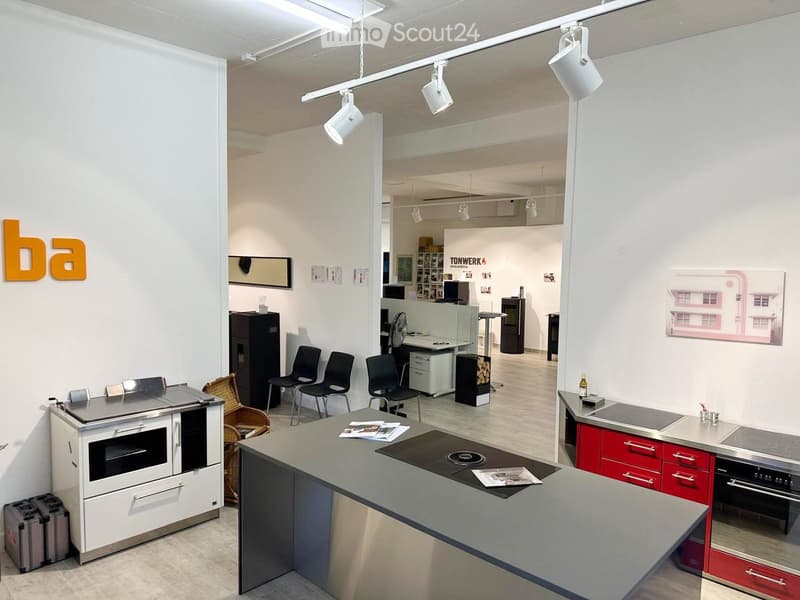 modern kitchen with stainless steel counter, modern kitchen appliances, wooden floor, white walls, three chairs in row, metal storage boxes