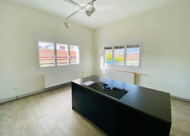 empty room, large kitchen island, two windows, two radiators
