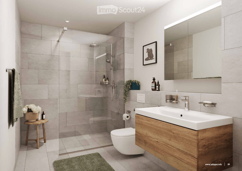 Modern bathroom with walk-in shower, toilet, vanity with sink, tiled flooring, wooden stool with flowers, mirror, framed artwork