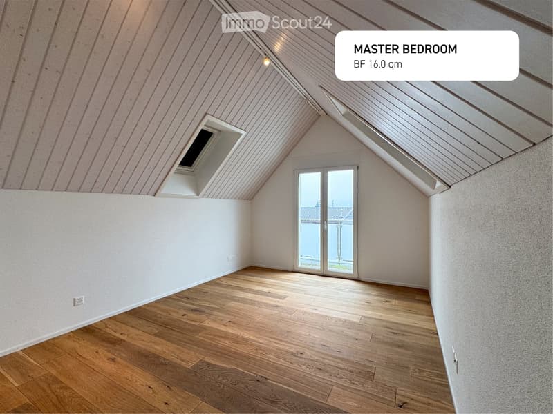 Master bedroom with hardwood floors, vaulted ceiling, skylight, and glass doors to a balcony.