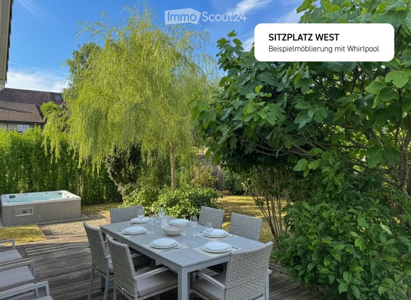 Dining table with chairs, jacuzzi, lush greenery, wooden deck
