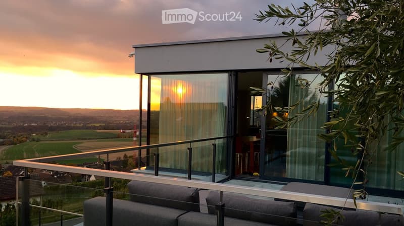 Outdoor sofa set, glass railings, glass sliding doors, panoramic view, sunset