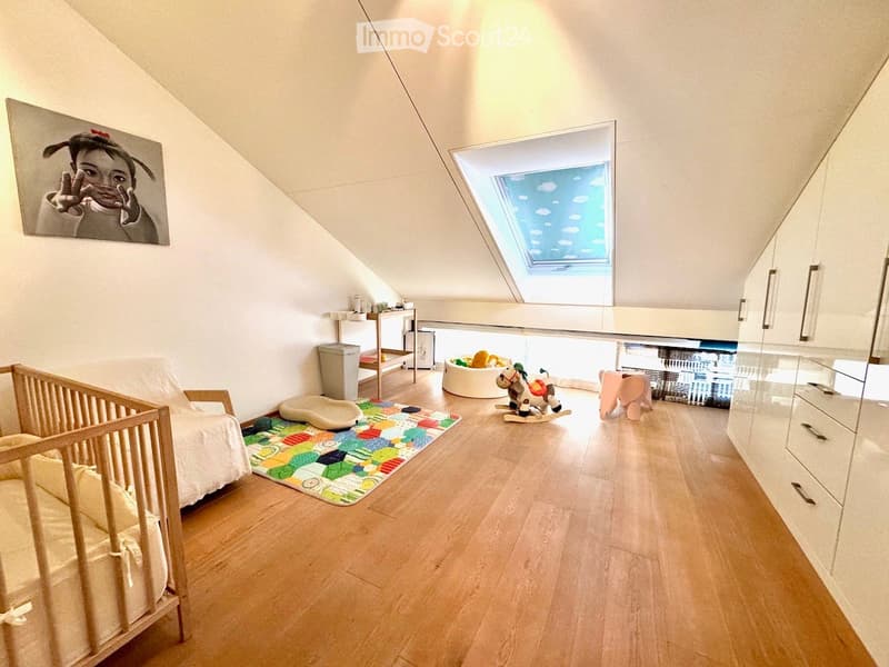 room with wooden floor, crib, toys, rack, and a small skylight