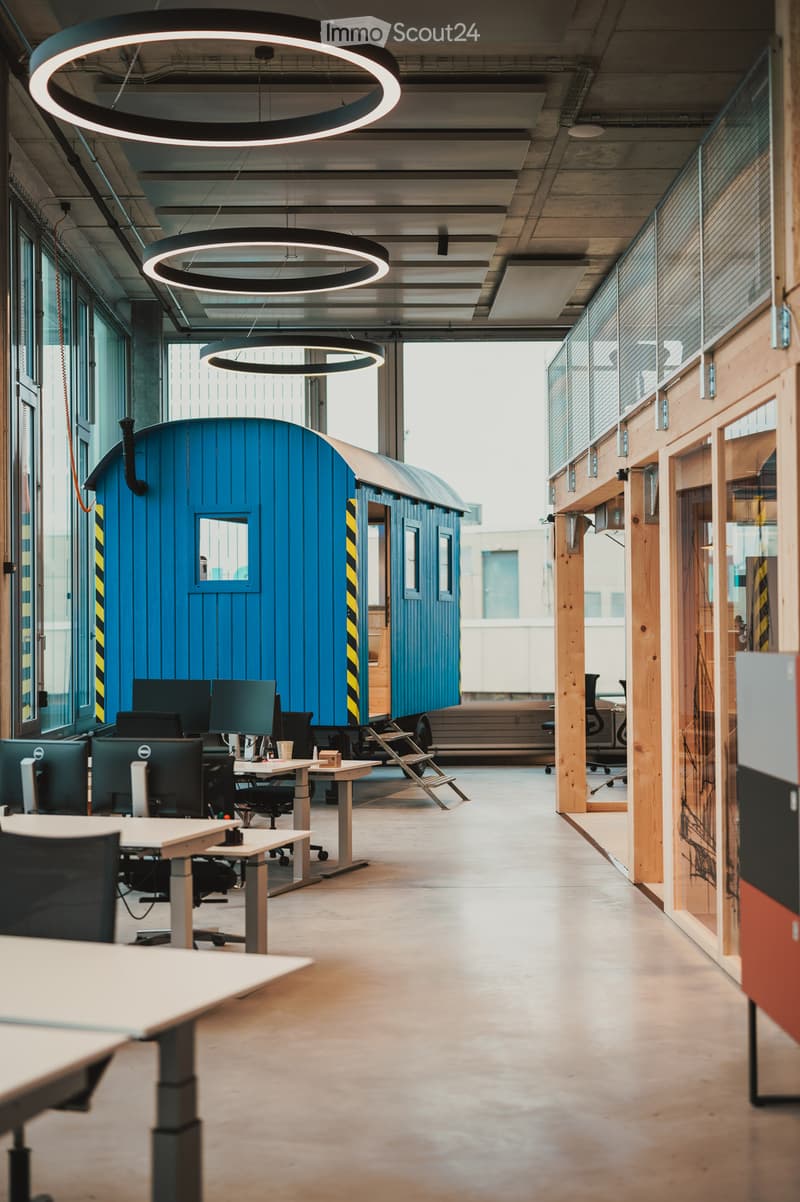 modern office, blue caravan, modern desks, circular lights, glass walls